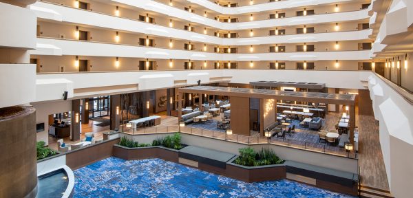 a hotel lobby with a pool in the middle.