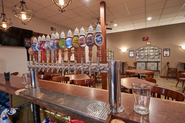 A bar with several beer taps in it.