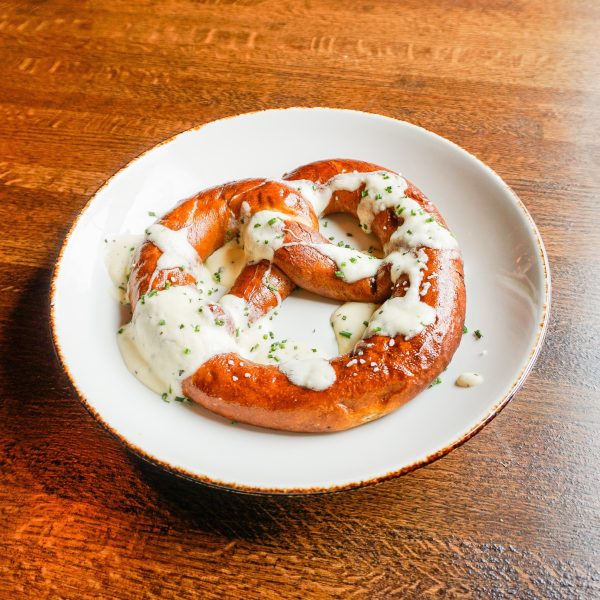 A white plate with a pretzel on it.