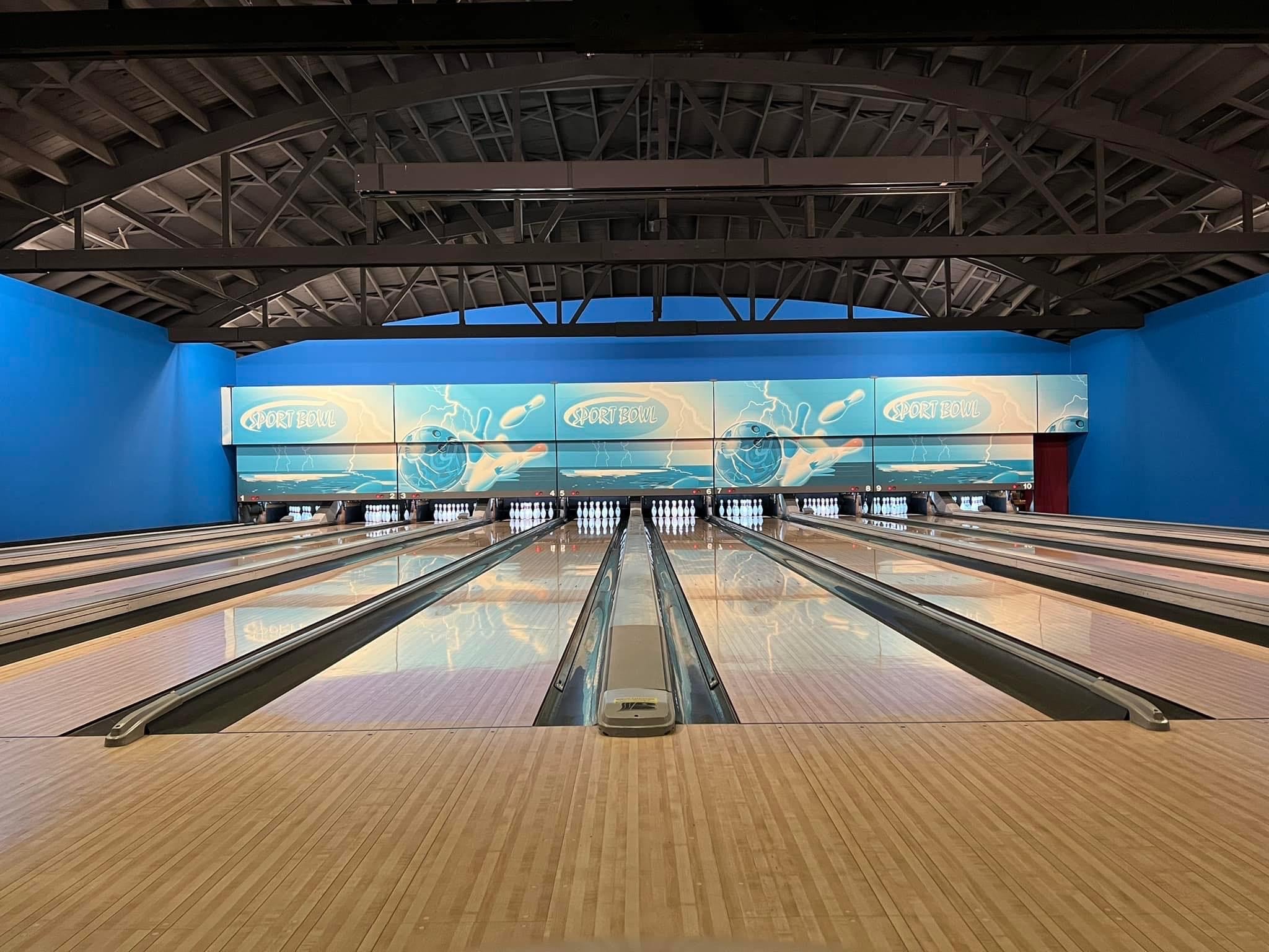 a bowling alley with a bowling ball going down it.