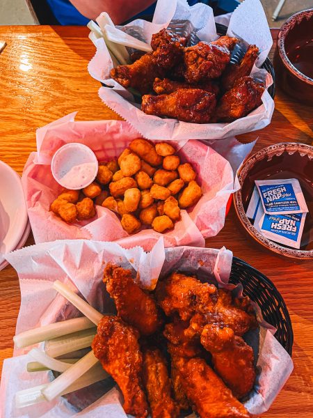 Two baskets of chicken wings on a table.