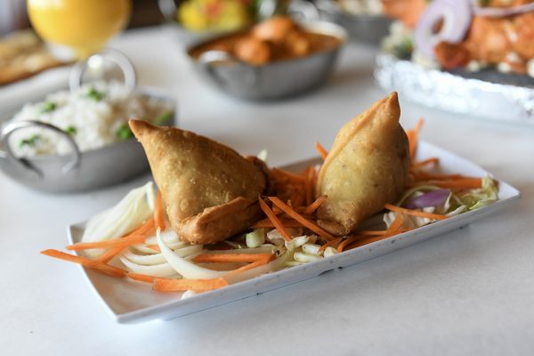 A plate of samosas on a table.