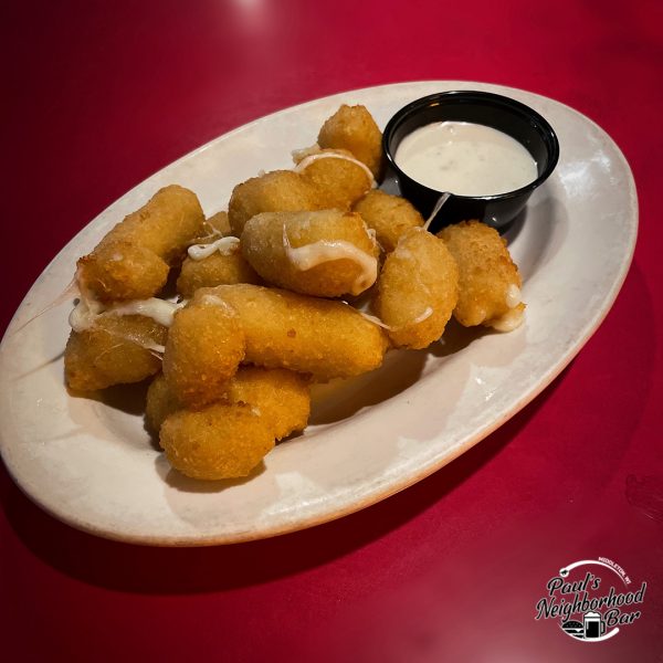 a white plate topped with tater tots and a dipping sauce.