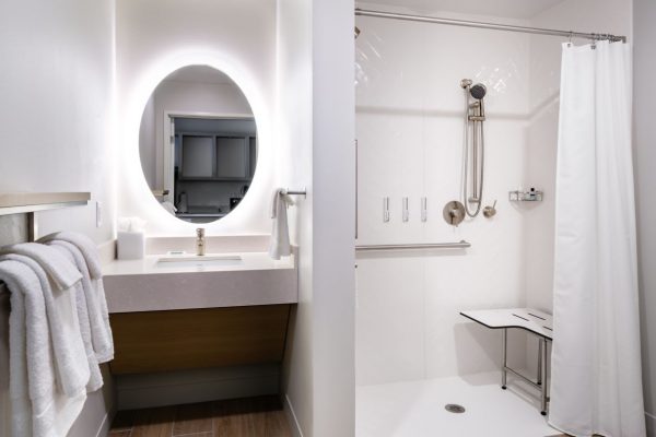 A bathroom with a shower, sink and toilet.