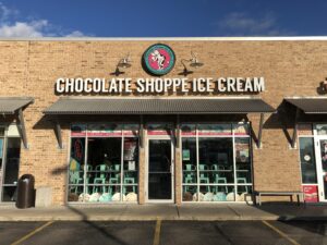 a chocolate shoppe ice cream store with chairs outside