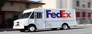 a fed ex truck driving down the street