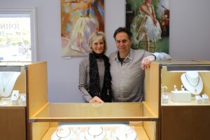a man and a woman standing in a jewelry store