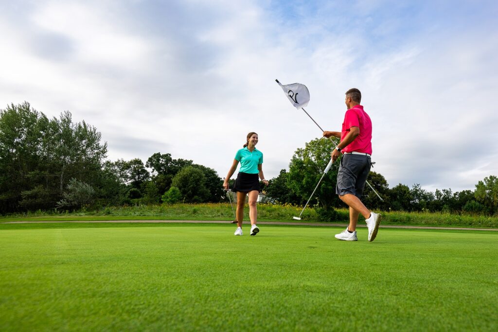 a man and a woman playing a game of golf