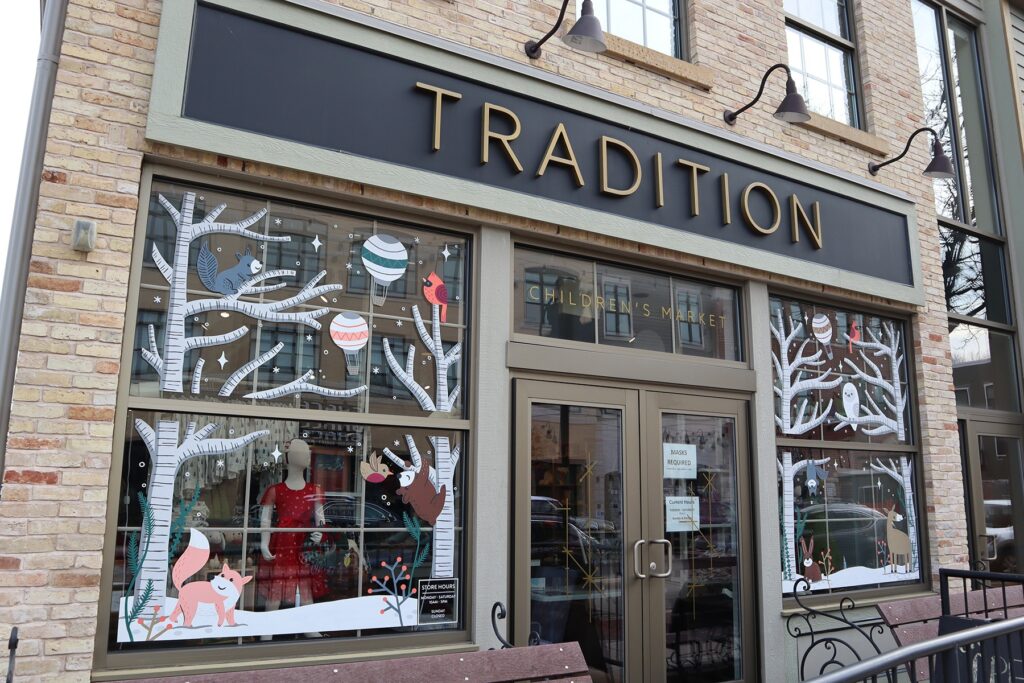Tradition Children clothing storefront with painted winter woodland scenes on each window
