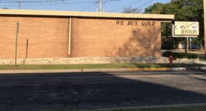 a brick building with a sign that says we buy gold
