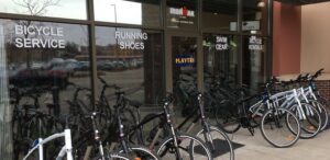 a bunch of bikes are parked outside of a bike shop
