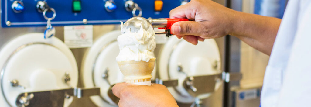 a person is using a machine to make ice cream