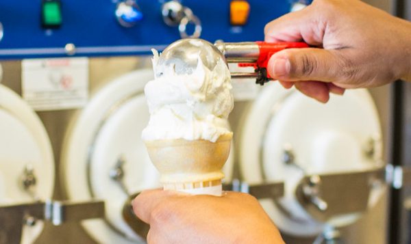 a person is using a machine to make ice cream