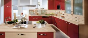 a kitchen with red cabinets and white counter tops