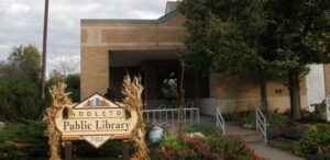 a public library sign in front of a building