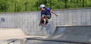 a man flying through the air while riding inline skates