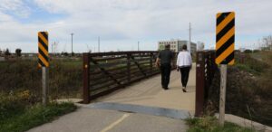 a man and a woman walking across a bridge