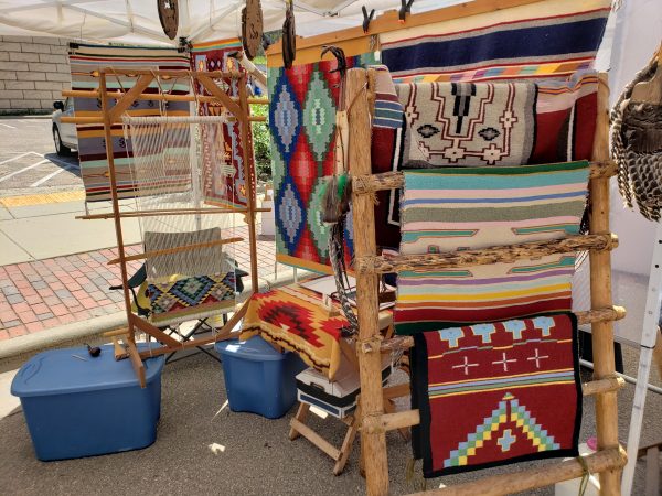 a display of blankets, rugs, and other decorative items.