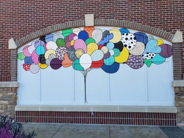 a large mural of balloons on the side of a building.