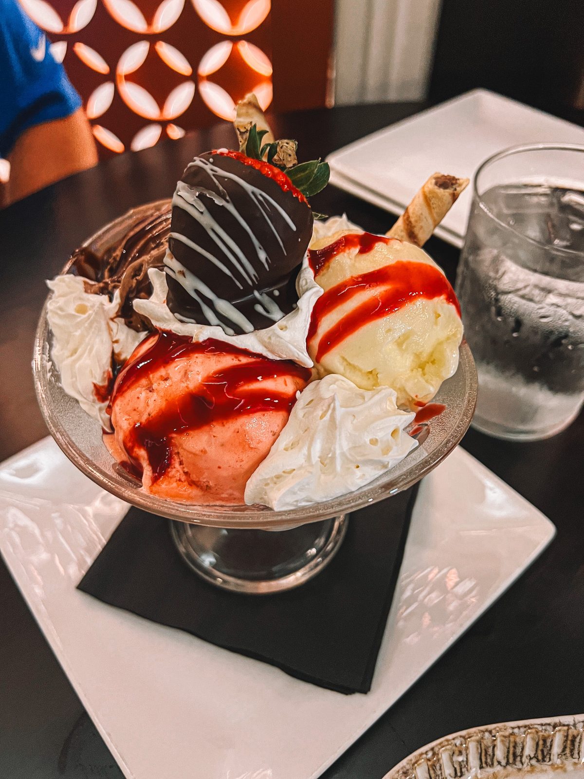 An ice cream sundae sitting on a table.