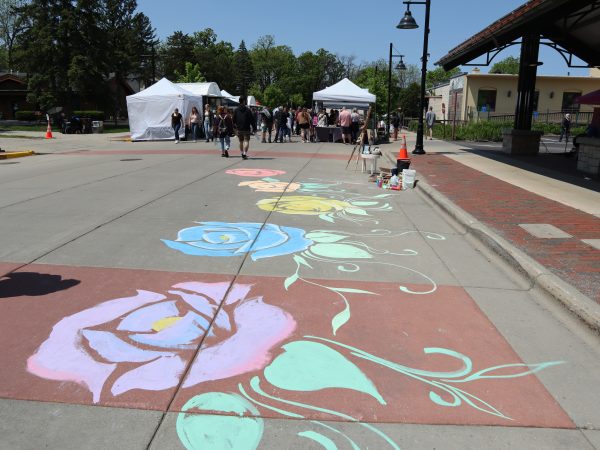 A sidewalk with flowers painted on it.