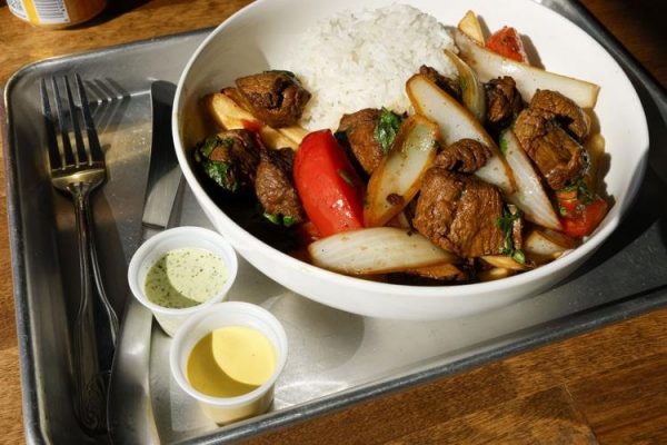 A bowl of beef, rice and vegetables on a tray.