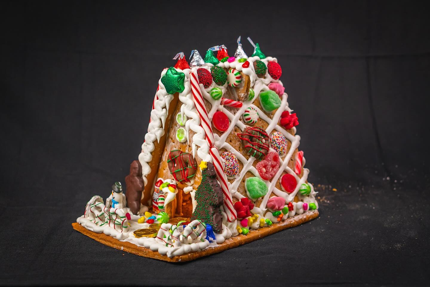 A gingerbread house decorated with candy and decorations.