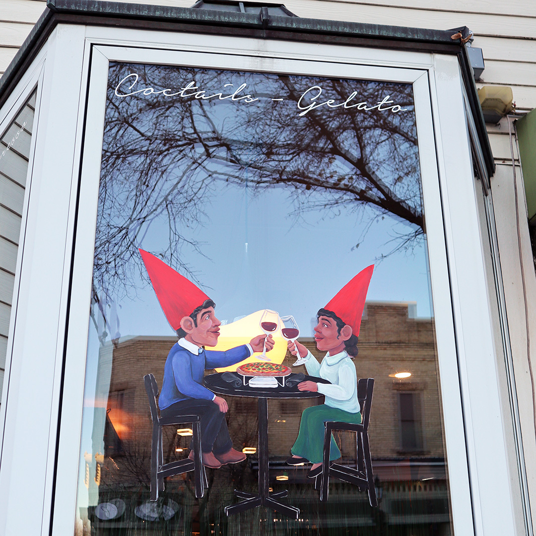 Two gnome hats on a window.