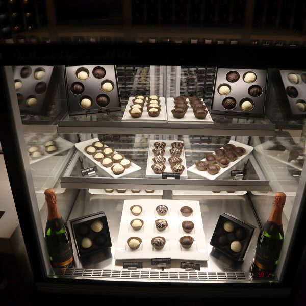 A display case filled with chocolates and champagne.