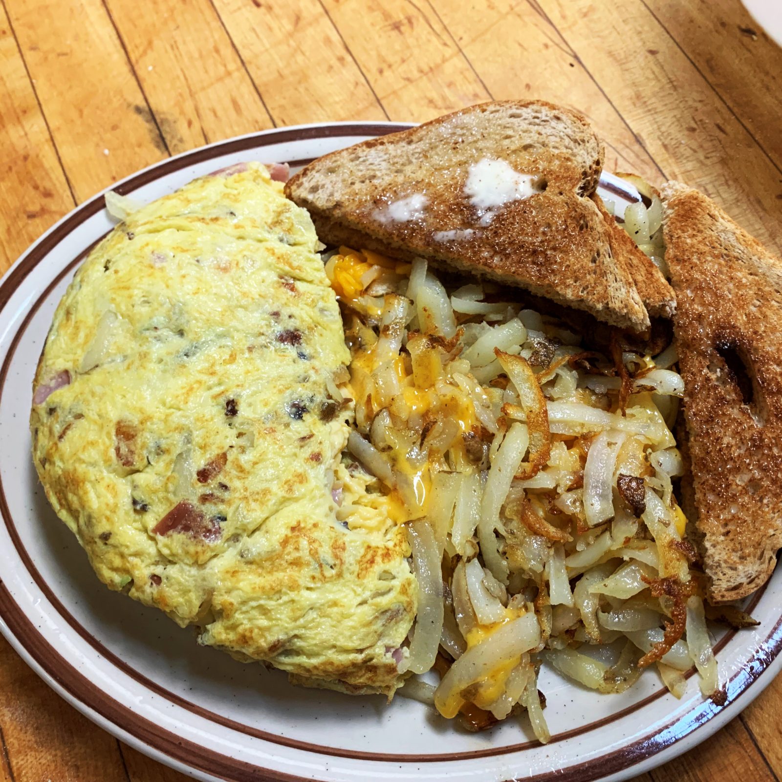 A plate with an omelet and toast.