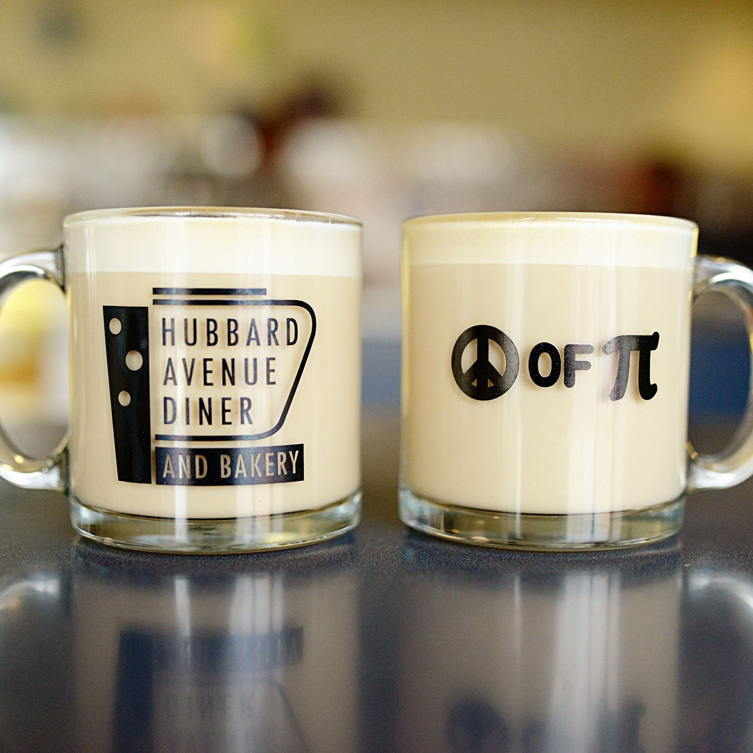 Two mugs sitting on a table.