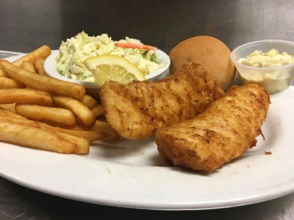 A plate with fish, fries and coleslaw.