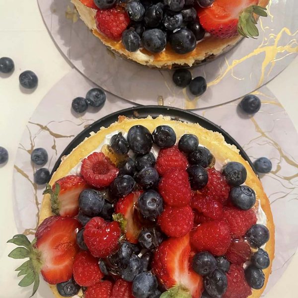 Berry-covered cheesecake by Krenare Custom Desserts