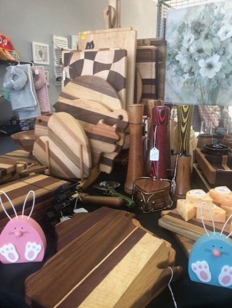 A display of wooden cutting boards and other items.