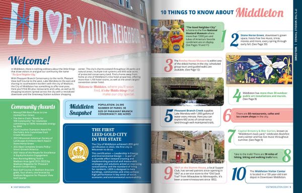 a couple and two children standing on a bridge in the woods.