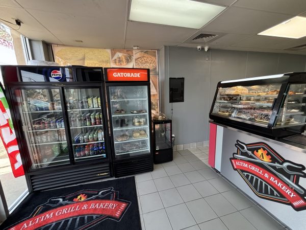 Altim Grill & Bakery interior featuring a refrigerated drink display, bakery pastry case, and tiled floor. Branded Altim Grill signs are visible on the counter and refrigerator.