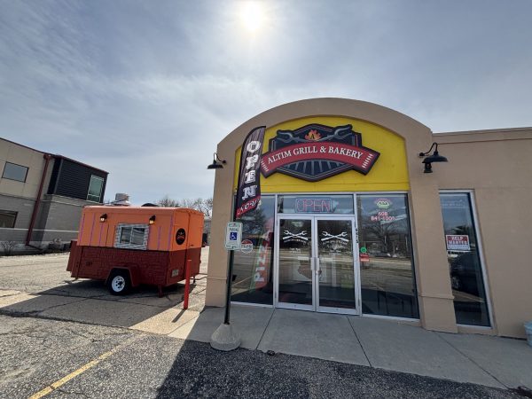 Exterior of Altin Grill & Bakery features a bold yellow and red bakery sign, glass doors with bright "OPEN" signs, and an orange food trailer parked outside Altin Grill.