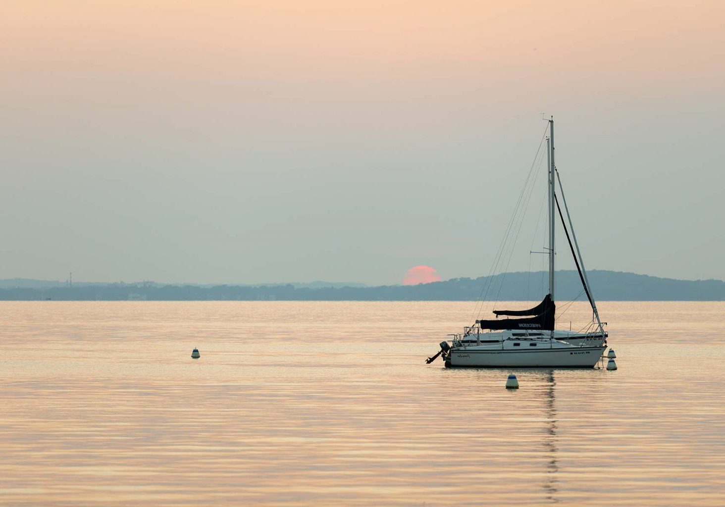 a sailboat floating in the middle of a body of water