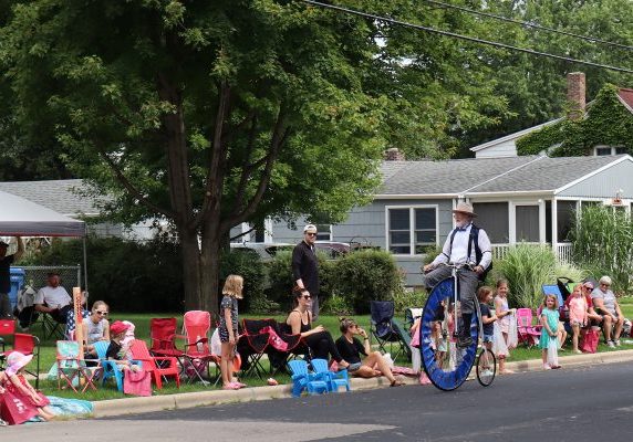 a man riding an unicycle on a street.