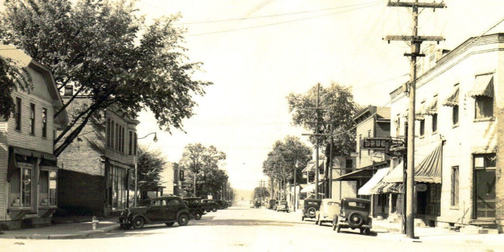 history-downtown an old black and white photo of a street